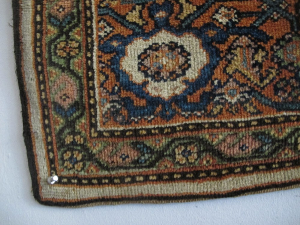 A rectangular antique Persian Fereghan rug with a detailed cream, terracotta, and navy Herati pattern bordered by intricate geometric bands. View XII