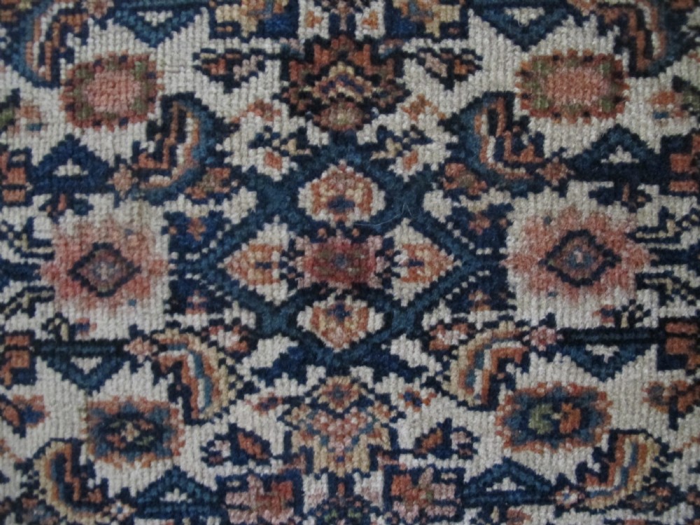 A rectangular antique Persian Fereghan rug with a detailed cream, terracotta, and navy Herati pattern bordered by intricate geometric bands. View XIII