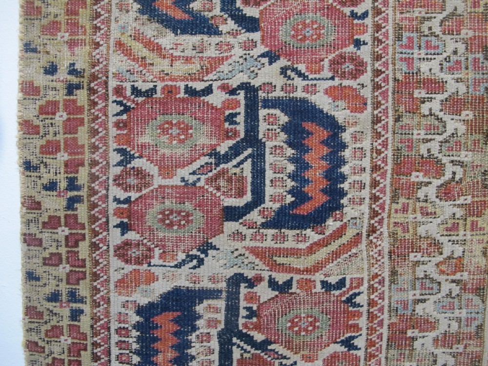 An 18th-century hand-knotted Ghiordes prayer rug featuring a central pale green mihrab niche framed by intricate floral borders in red, blue, and beige. View III