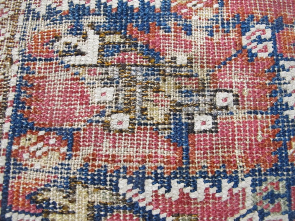 An 18th-century hand-knotted Ghiordes prayer rug featuring a central pale green mihrab niche framed by intricate floral borders in red, blue, and beige. View XI