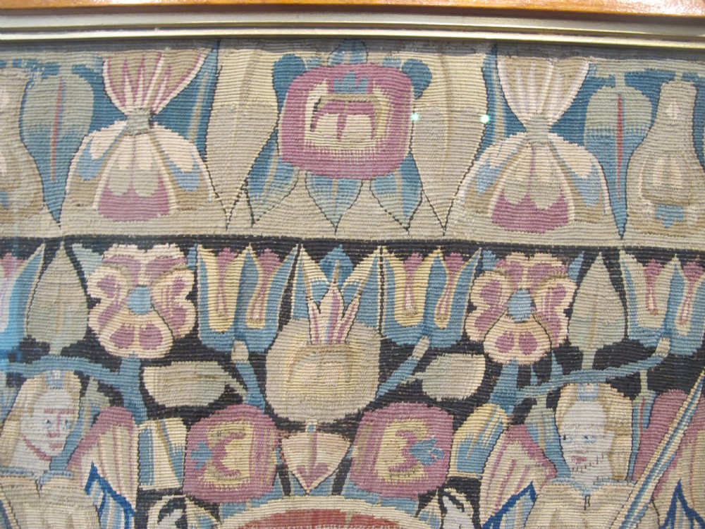 A pair of square 17th-century North German tapestry panels featuring allegorical figures and floral borders, presented in wooden frames. View XI