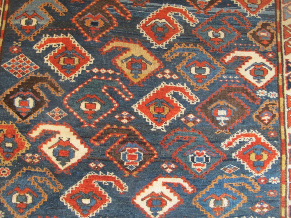 An antique late 19th-century North-West Persian hand-knotted wool runner rug featuring repeating geometric hook motifs on a dark blue field framed by geometric borders. View V