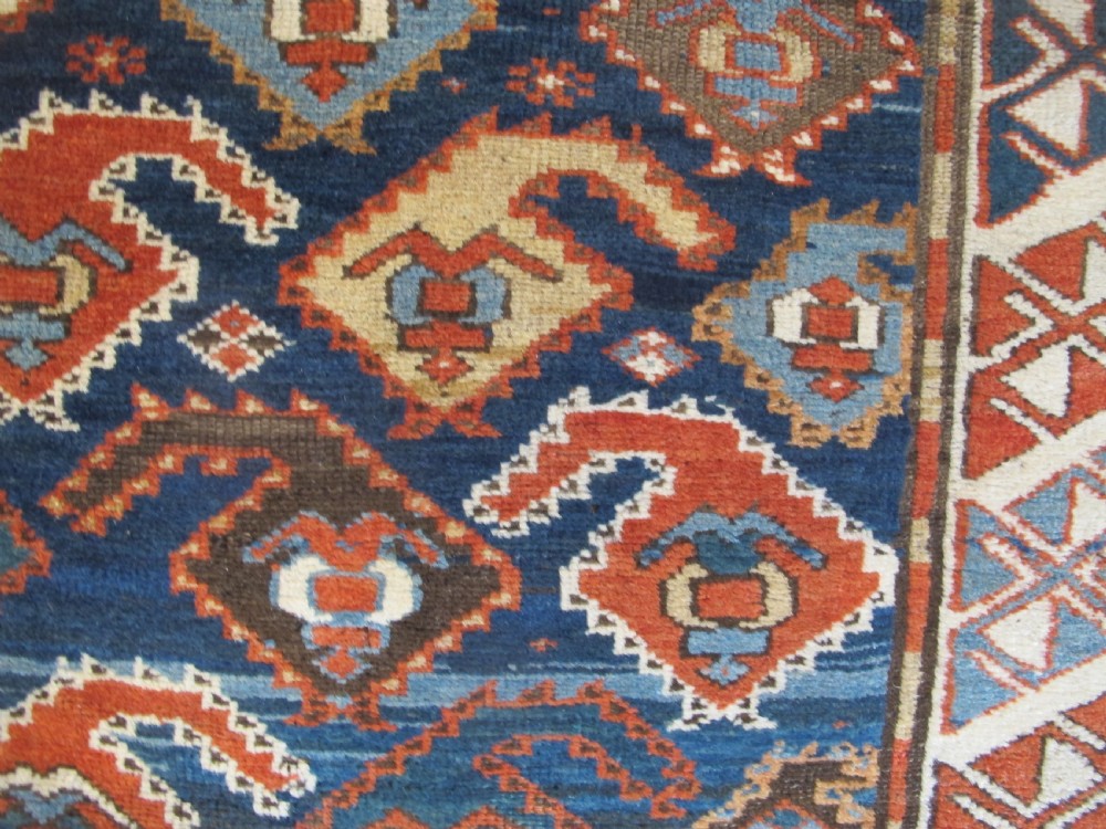 An antique late 19th-century North-West Persian hand-knotted wool runner rug featuring repeating geometric hook motifs on a dark blue field framed by geometric borders. View VI