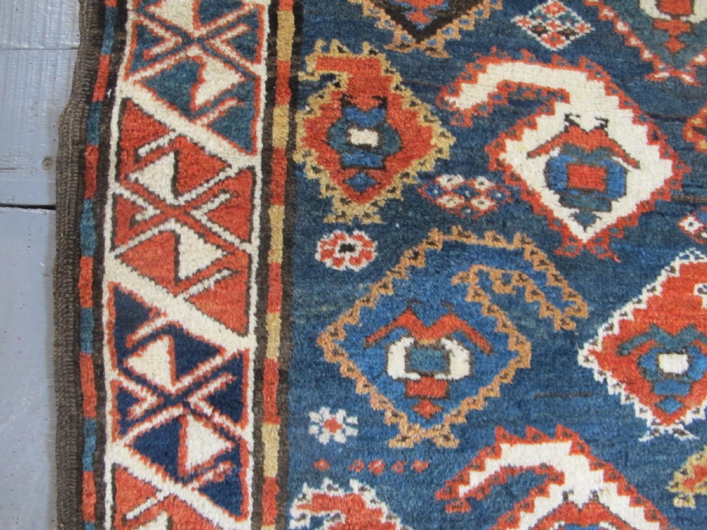 An antique late 19th-century North-West Persian hand-knotted wool runner rug featuring repeating geometric hook motifs on a dark blue field framed by geometric borders. View VIII