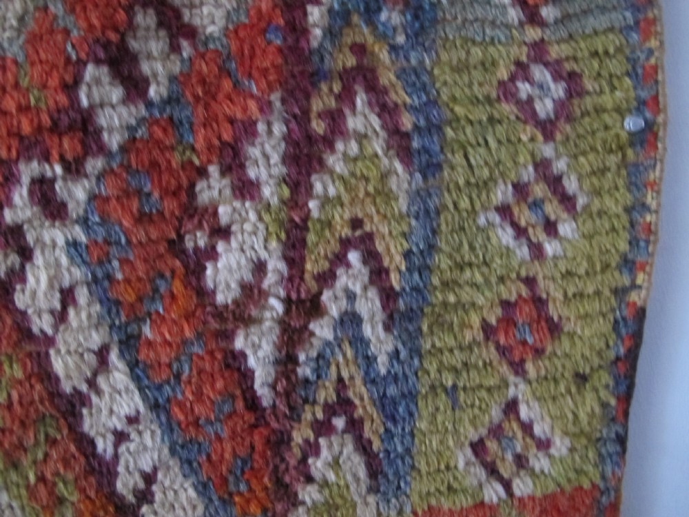 An antique rectangular Moroccan Glaoui rug featuring geometric diamond and chevron patterns in terracotta red, ochre, cream, and charcoal tones. View IV
