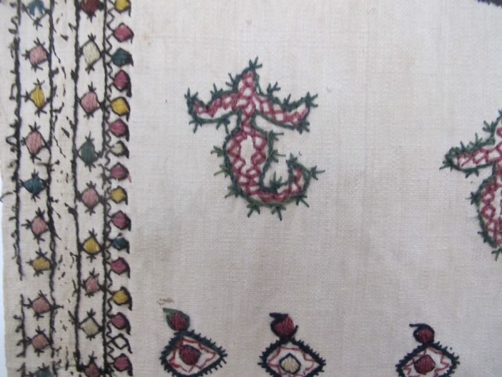 A square cream silk embroidered textile with a central circular medallion surrounded by repeating rows of small boteh motifs and a patterned border. View V