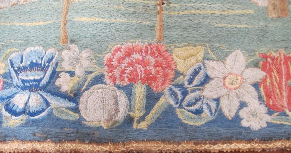 An antique square silk needlework panel displaying figurative pastoral scenes inside a wide floral border. View VIII