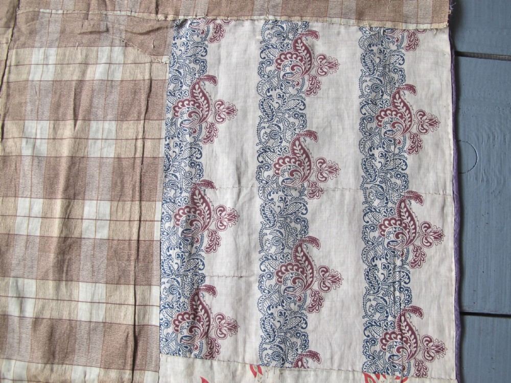 A rectangular antique silk-embroidered Suzani textile featuring crimson floral motifs and scrolling leaf borders on a beige cotton ground. View XVI