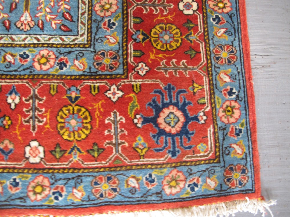 A rectangular hand-knotted Persian Qum rug featuring a central field of grid compartments filled with botanical and cypress motifs framed by a red border. View IV