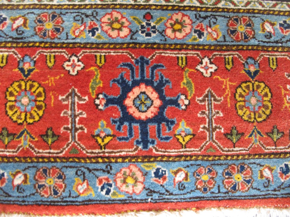 A rectangular hand-knotted Persian Qum rug featuring a central field of grid compartments filled with botanical and cypress motifs framed by a red border. View V