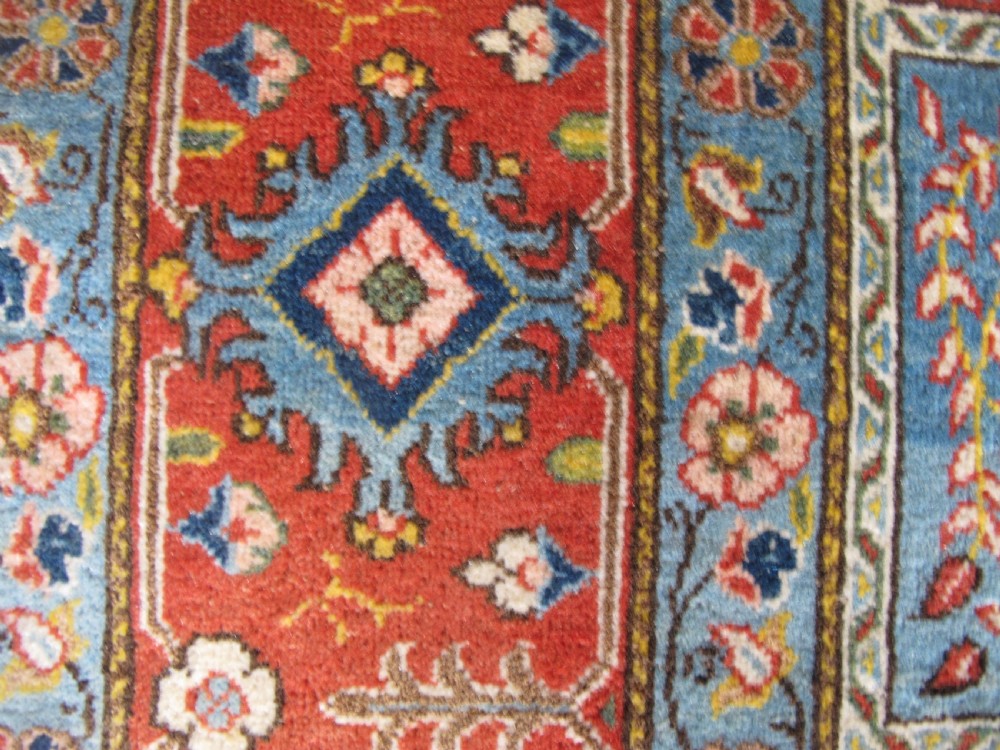 A rectangular hand-knotted Persian Qum rug featuring a central field of grid compartments filled with botanical and cypress motifs framed by a red border. View XII