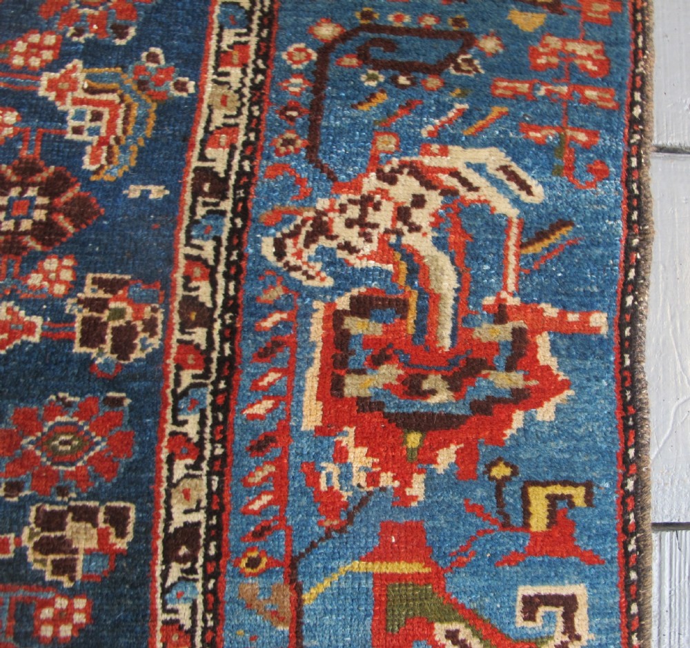 A late 19th-century hand-knotted Persian Hamadan wool rug featuring a dark navy central field surrounded by vibrant blue and red borders with intricate geometric floral motifs. View IX