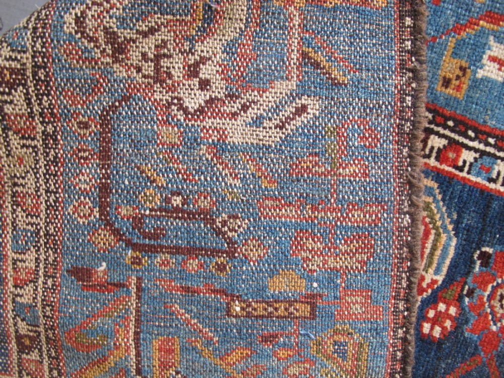 A late 19th-century hand-knotted Persian Hamadan wool rug featuring a dark navy central field surrounded by vibrant blue and red borders with intricate geometric floral motifs. View XIV