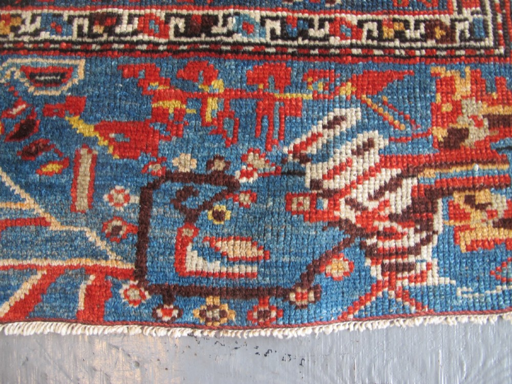 A late 19th-century hand-knotted Persian Hamadan wool rug featuring a dark navy central field surrounded by vibrant blue and red borders with intricate geometric floral motifs. View XVII