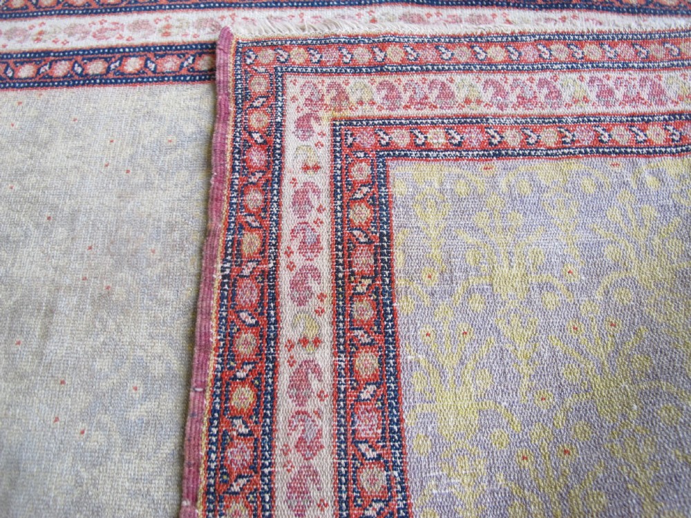 A pair of late nineteenth-century Persian Senneh hand-knotted wool rugs featuring pale cream central fields and multi-stripe red borders. View XI