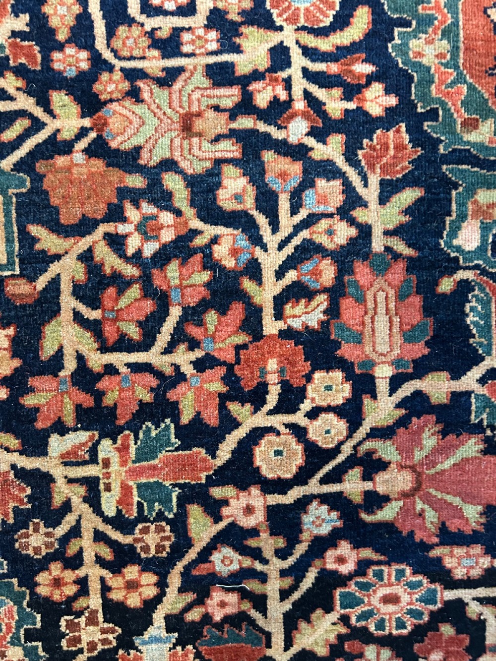 An antique Persian Fereghan carpet featuring an intricate central medallion on a dark navy field surrounded by detailed floral spandrels and terracotta borders. View II