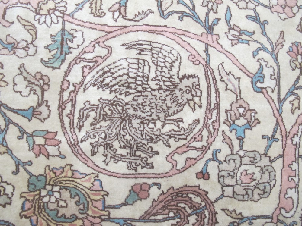 A large hand-knotted Persian Tabriz wool carpet featuring a central cream and terracotta medallion surrounded by intricate floral arabesques and border detail. View IX