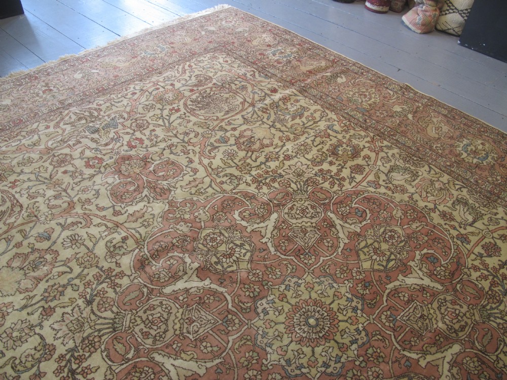 A large hand-knotted Persian Tabriz wool carpet featuring a central cream and terracotta medallion surrounded by intricate floral arabesques and border detail. View XI