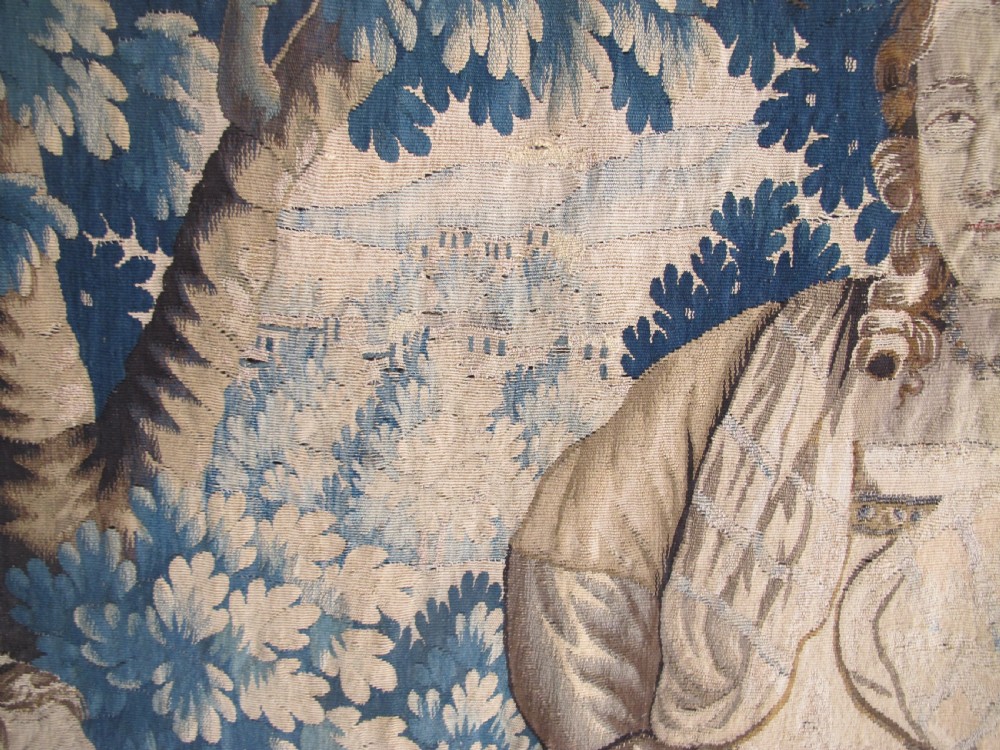A large 17th-century woven Aubusson tapestry displaying a biblical scene with figures, hounds, and foliage in shades of blue, cream, and green. View XIII