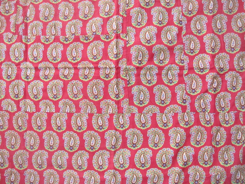 A square late nineteenth-century Indian cotton blockprint panel featuring a dense red, yellow, and green paisley pattern within a thin border. View II