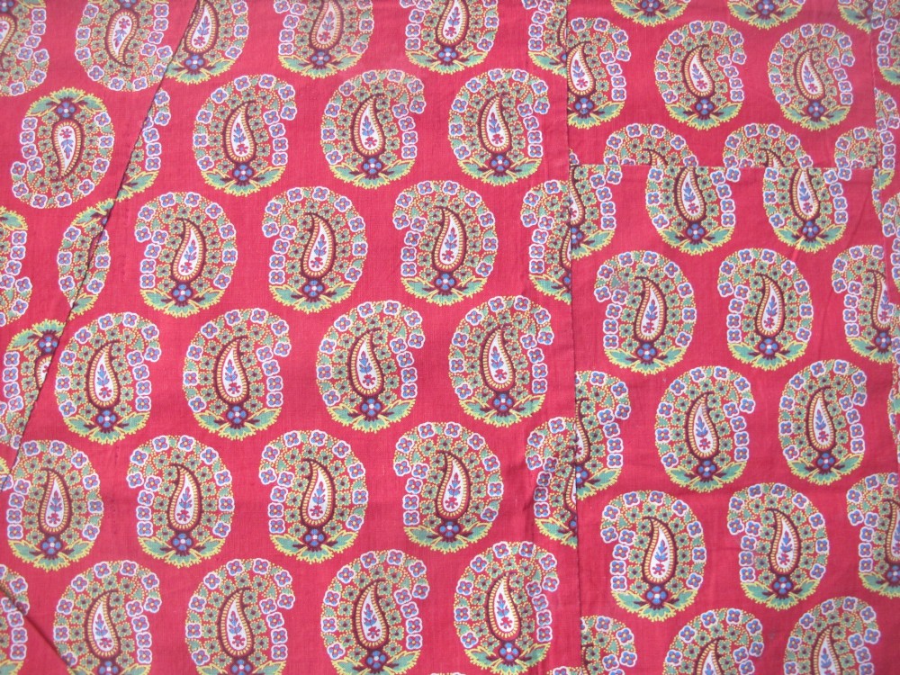 A square late nineteenth-century Indian cotton blockprint panel featuring a dense red, yellow, and green paisley pattern within a thin border. View III