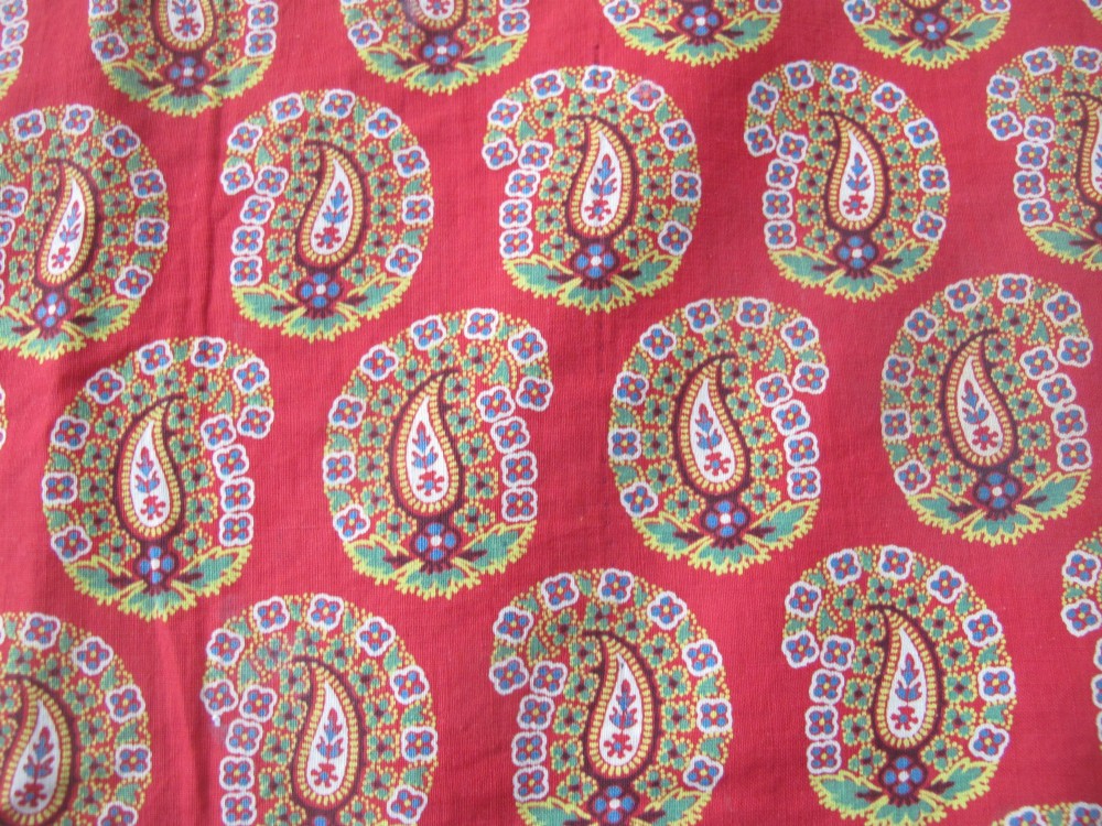 A square late nineteenth-century Indian cotton blockprint panel featuring a dense red, yellow, and green paisley pattern within a thin border. View V