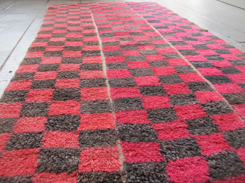 An antique Tibetan wool meditation rug featuring a three-panel chequerboard pattern in pink and dark grey. View II