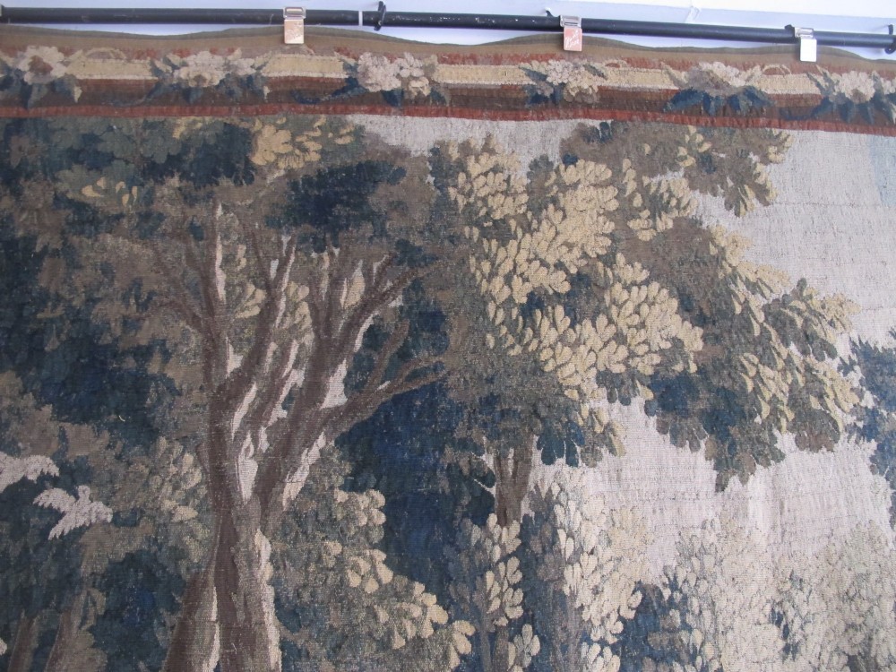 A large late 18th-century French woven tapestry portraying a pastoral scene with dancing figures, a stone building, and leafy trees enclosed within a decorative floral border. View VIII