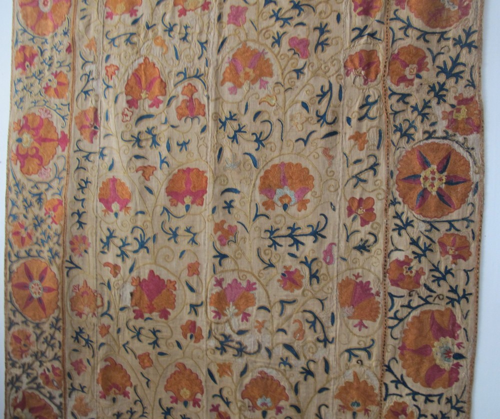 A rectangular hand-embroidered cream cotton textile decorated with orange, pink, and green silk floral roundels and scrolling vine borders. View XIII