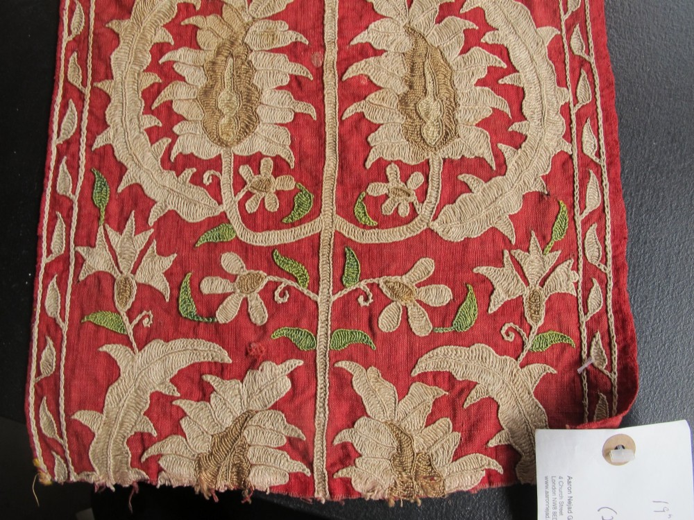 A long, narrow 19th-century Ottoman textile fragment featuring intricate gold botanical embroidery on a vibrant red background. View III
