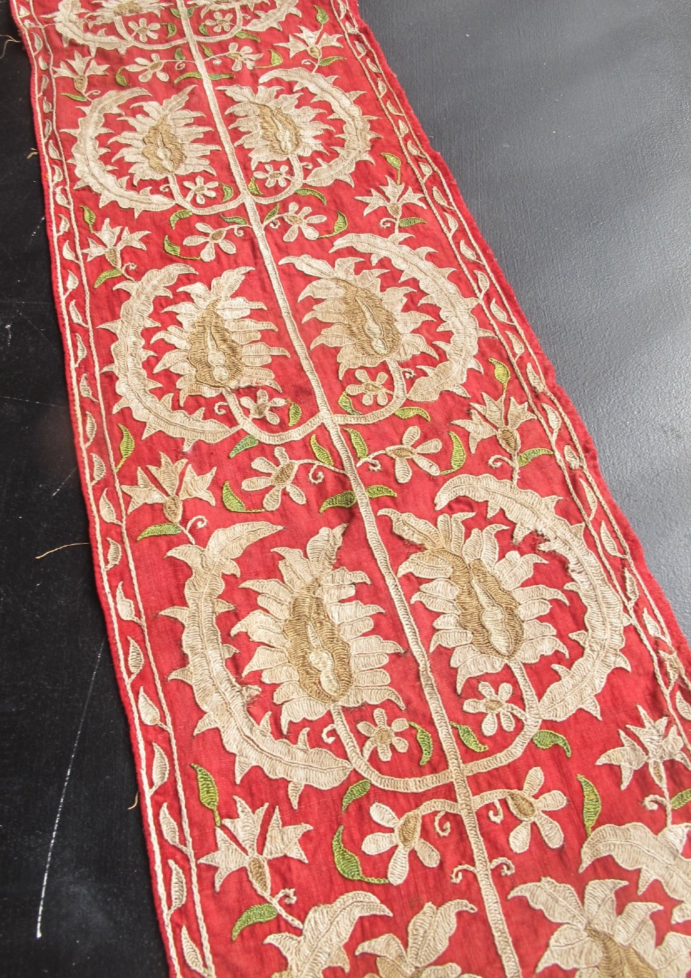 A long, narrow 19th-century Ottoman textile fragment featuring intricate gold botanical embroidery on a vibrant red background. View IX