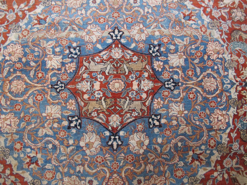 An antique Persian Tabriz carpet featuring a central medallion surrounded by floral motifs in terracotta and pale blue with calligraphic border cartouches. View IV