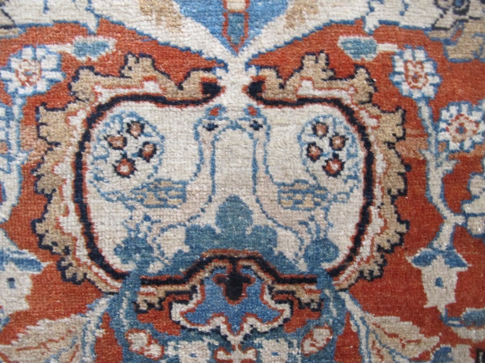 An antique Persian Tabriz carpet featuring a central medallion surrounded by floral motifs in terracotta and pale blue with calligraphic border cartouches. View VIII