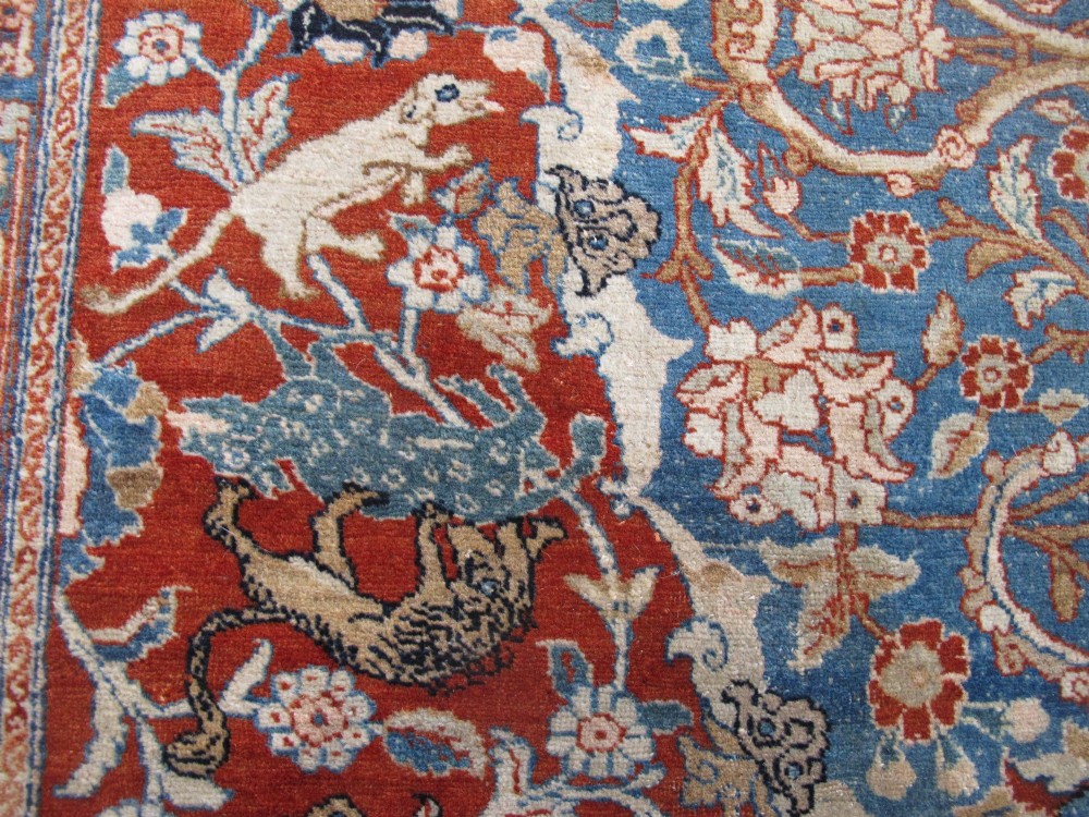 An antique Persian Tabriz carpet featuring a central medallion surrounded by floral motifs in terracotta and pale blue with calligraphic border cartouches. View IX