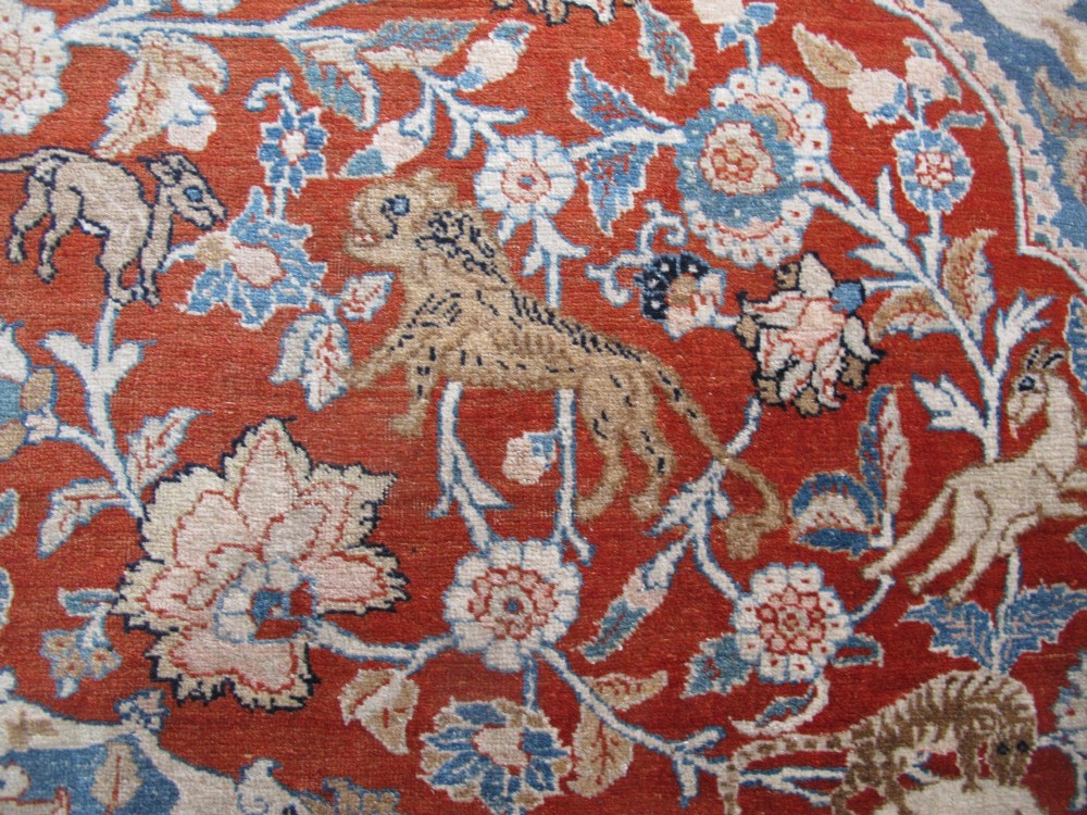 An antique Persian Tabriz carpet featuring a central medallion surrounded by floral motifs in terracotta and pale blue with calligraphic border cartouches. View XI