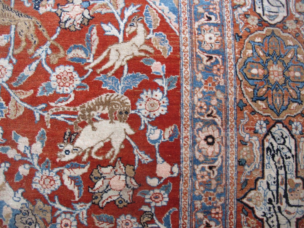 An antique Persian Tabriz carpet featuring a central medallion surrounded by floral motifs in terracotta and pale blue with calligraphic border cartouches. View XII