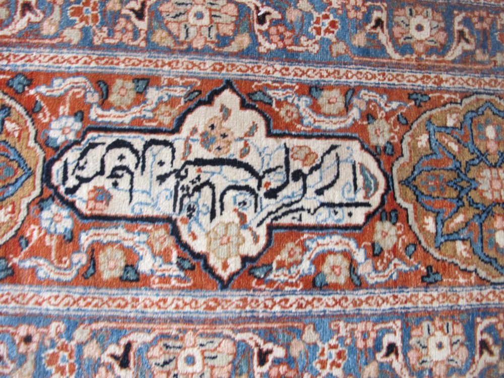 An antique Persian Tabriz carpet featuring a central medallion surrounded by floral motifs in terracotta and pale blue with calligraphic border cartouches. View XIII
