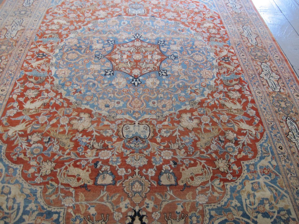 An antique Persian Tabriz carpet featuring a central medallion surrounded by floral motifs in terracotta and pale blue with calligraphic border cartouches. View XIV