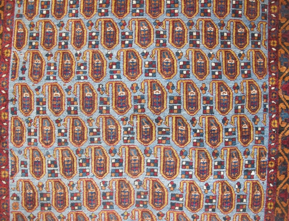 An antique hand-knotted Persian Afshar wool rug featuring repeating boteh motifs on a light blue field with multi-band patterned borders. View II