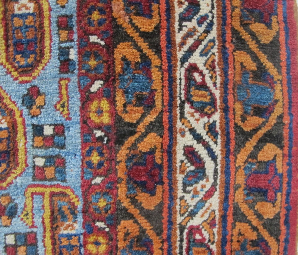 An antique hand-knotted Persian Afshar wool rug featuring repeating boteh motifs on a light blue field with multi-band patterned borders. View VI