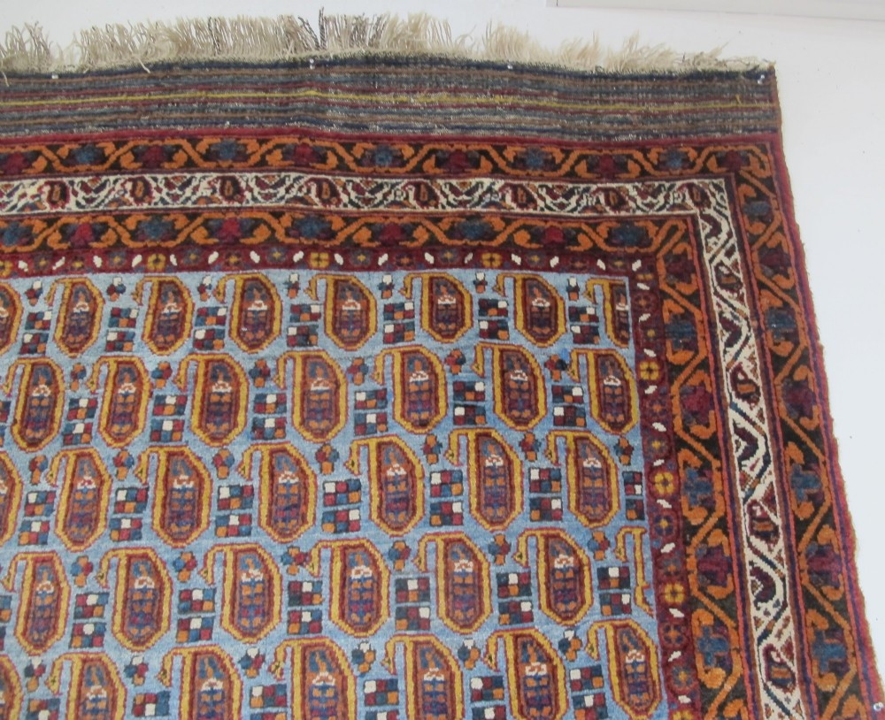 An antique hand-knotted Persian Afshar wool rug featuring repeating boteh motifs on a light blue field with multi-band patterned borders. View VII