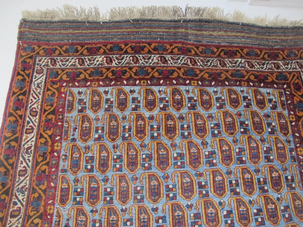 An antique hand-knotted Persian Afshar wool rug featuring repeating boteh motifs on a light blue field with multi-band patterned borders. View VIII