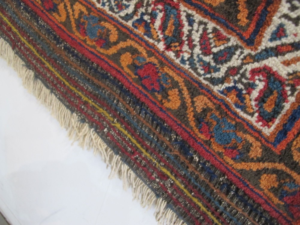 An antique hand-knotted Persian Afshar wool rug featuring repeating boteh motifs on a light blue field with multi-band patterned borders. View X