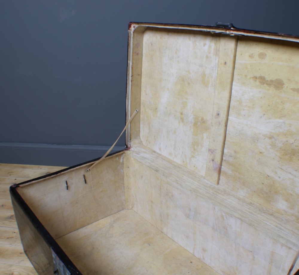 A large rectangular black lacquered oriental pigskin shipping trunk featuring a central metal latch plate. View VIII