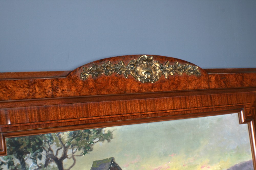 A tall rectangular French walnut wall mirror featuring an inset oil painting of a landscape above a large rectangular glass pane. View V