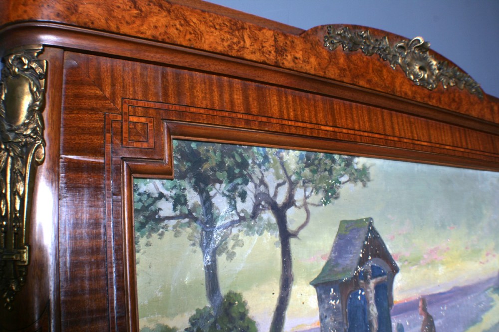 A tall rectangular French walnut wall mirror featuring an inset oil painting of a landscape above a large rectangular glass pane. View IX