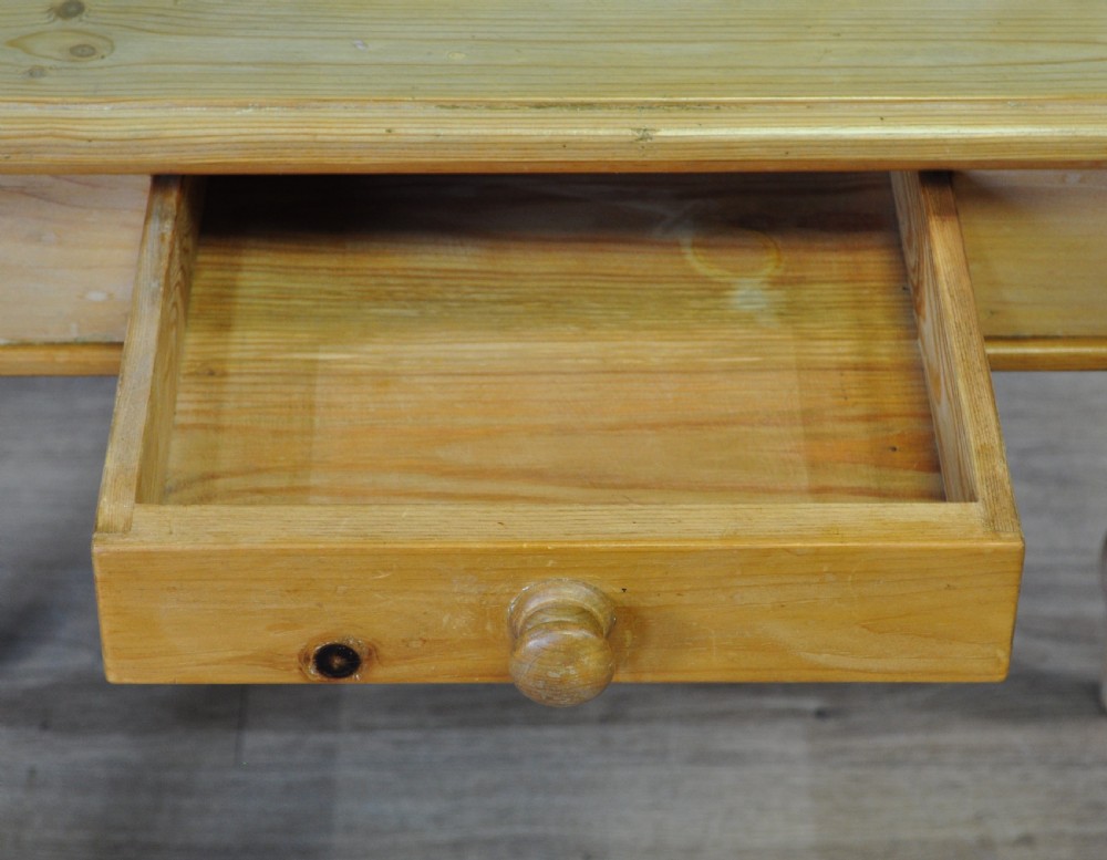 An antique Victorian pine washstand featuring a raised gallery splashback set with four green embossed tiles, a single frieze drawer, and turned legs. View IV