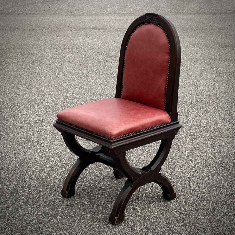 Attractive Antique Gothic Style Leather Chair With X Frame Legs