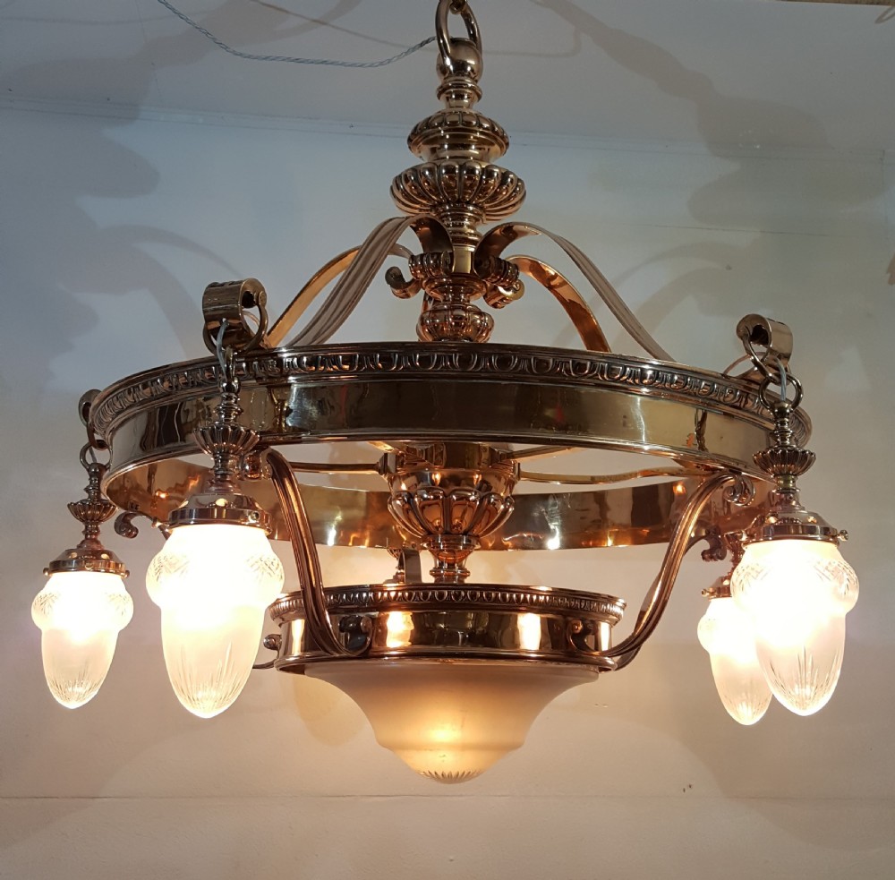A Victorian style polished bronze and brass ceiling light fixture featuring a central ring frame with scrolled upper supports and frosted cut glass shades. View II