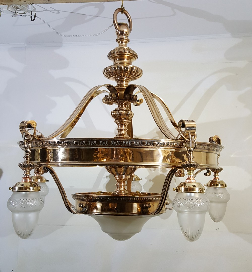 A Victorian style polished bronze and brass ceiling light fixture featuring a central ring frame with scrolled upper supports and frosted cut glass shades. View IV